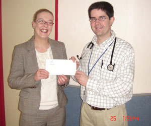 Lorna Creighton (Critical Care Representative, Leo Pharma) presents his prize to Dr Stuart Carr (SpR in Emergency Medicine, St Vincent's University Hospital)